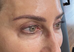A close up of a person 's eyes with brown eye makeup.