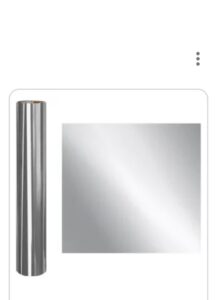 A mirror with a silver frame and a white background
