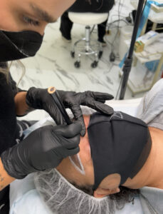 A person getting their tattoo done by someone else