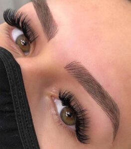 A close up of a person 's eyes with fake lashes