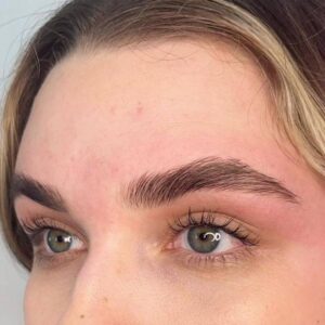 A close up of a person 's eyes with brown eyebrows