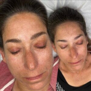 A woman with her eyes closed and another woman with her face down.