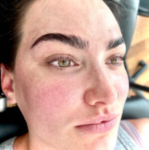 A woman with brown eyes and black hair.
