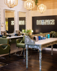 A salon with two mirrors and tables in the center.