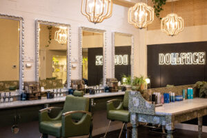 A room with many mirrors and chairs in it