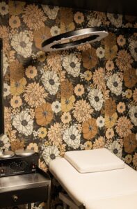 A room with a wall covered in flowers.