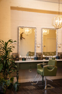 A room with three mirrors and two chairs