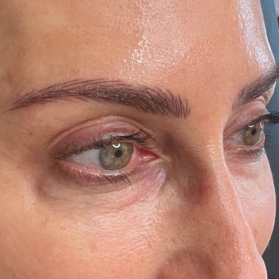 A close up of a person 's eyes with brown eye makeup.